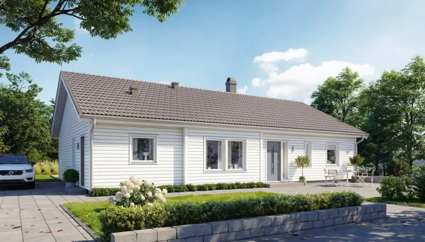 Vitt, modernt betong hus med grå takpannor, omgivet av grönska och träd. En vit bil parkerad på uppfarten.
