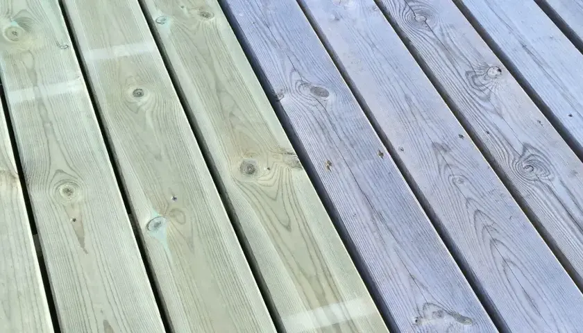 Trallen har fått en ny behandling. Halva däcket är nymålat i en ljusgrön nyans, medan andra halvan visar den gråa, väderbitna ytan.