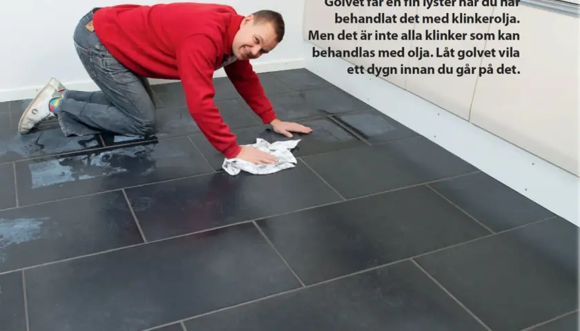Man polerar ett mörkt klinkergolv med en trasa. Golvet får en fin lyster efter behandling med klinkerolja, men inte alla klinker passar för detta.